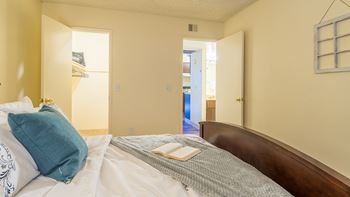 The Springs bedroom with carpet flooring and nice lighting